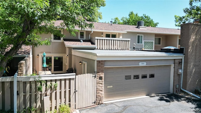 view of front of home featuring a balcony and a garage