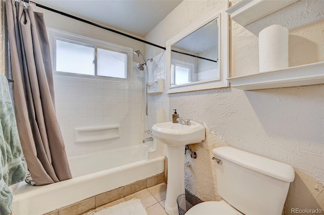 full bathroom with toilet, sink, tile patterned floors, and shower / tub combo with curtain