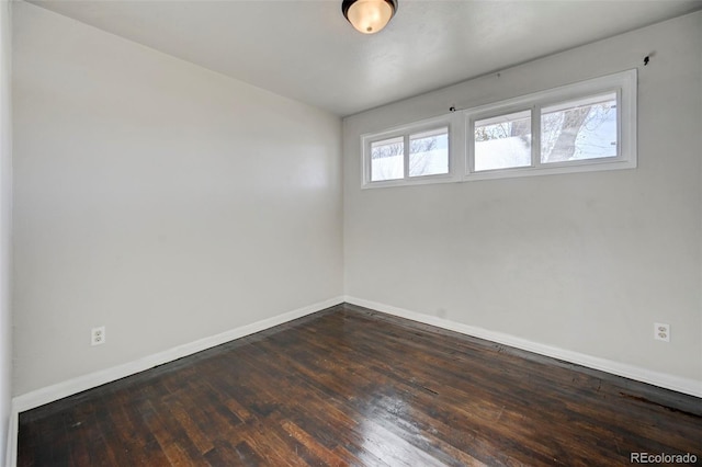 unfurnished room with dark hardwood / wood-style flooring