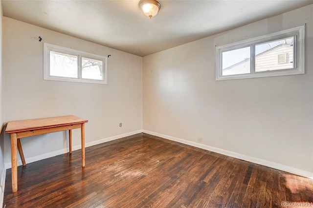 spare room featuring dark hardwood / wood-style flooring