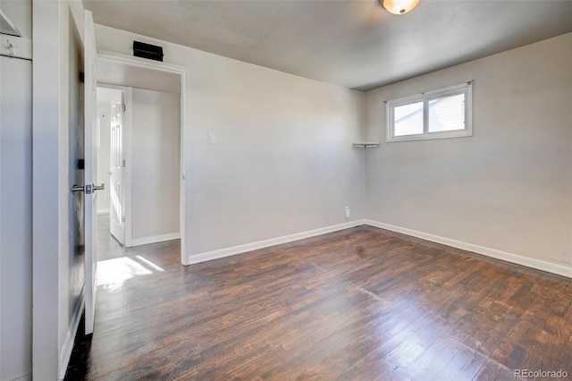 empty room with dark wood-type flooring