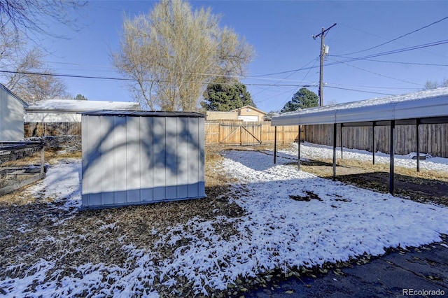 snowy yard with a shed