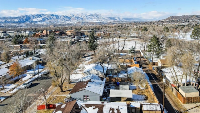 snowy aerial view featuring a mountain view