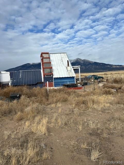 view of outdoor structure featuring a mountain view and a rural view