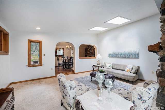 living area with arched walkways, baseboards, carpet, and recessed lighting