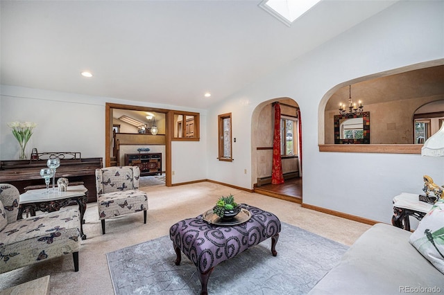living room with carpet flooring, an inviting chandelier, arched walkways, recessed lighting, and lofted ceiling with skylight