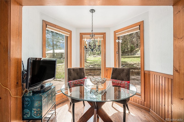 dining space featuring wainscoting and light wood finished floors