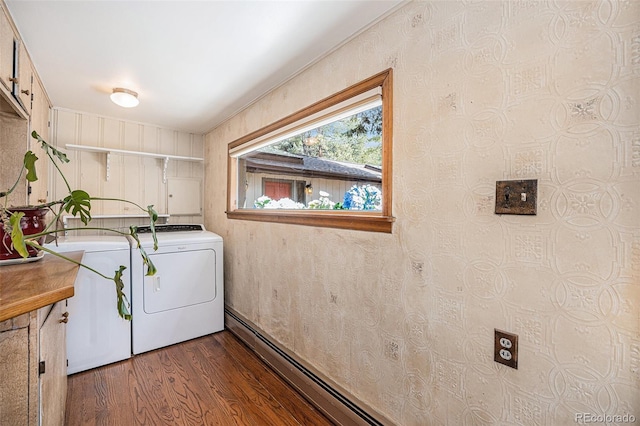 clothes washing area with dark wood finished floors, cabinet space, and washer and dryer