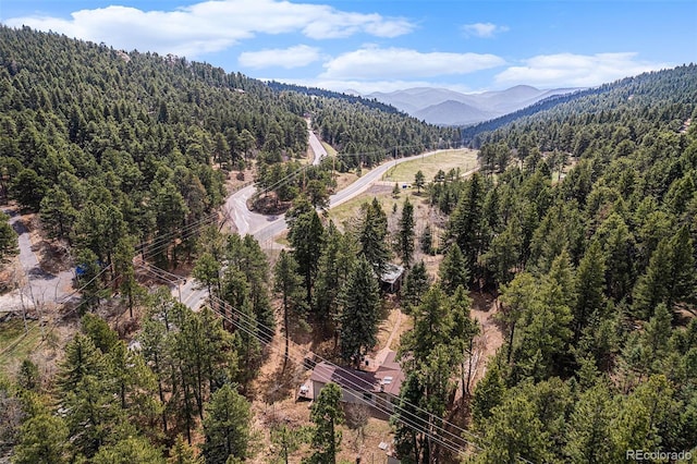 aerial view with a mountain view and a forest view