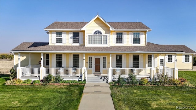 view of front of home with a porch and a front yard