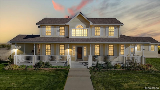 view of front of home with a yard and a porch