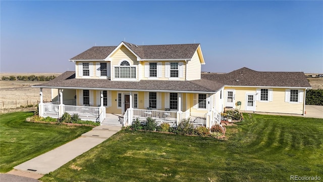 farmhouse-style home with a front lawn and a porch