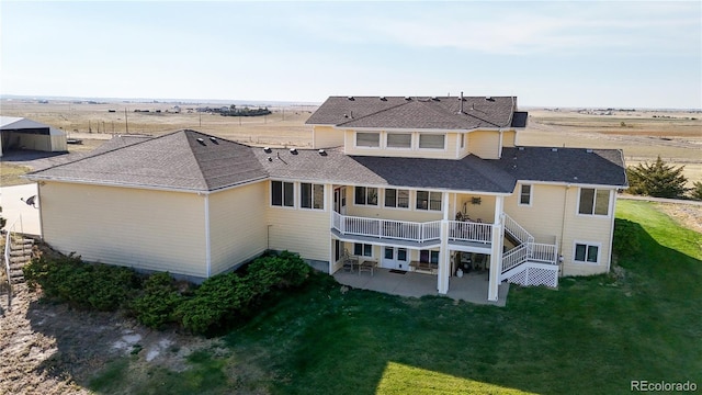 back of house featuring a patio area and a lawn