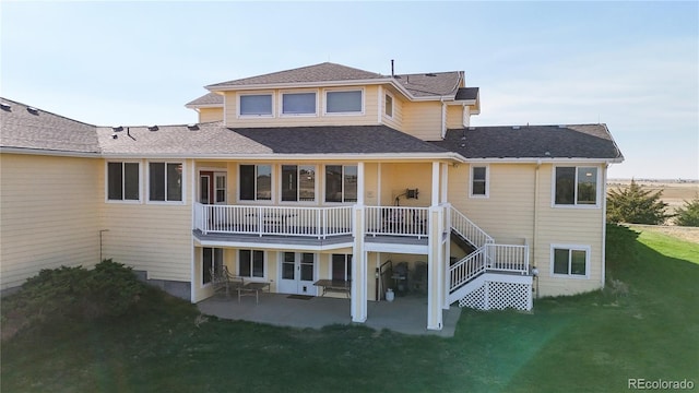 rear view of house featuring a yard and a patio area