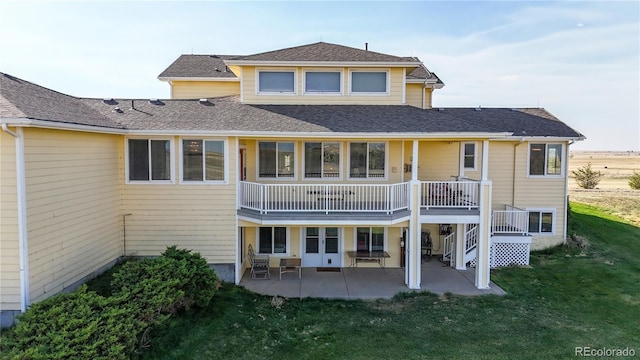 back of property with a lawn and a patio