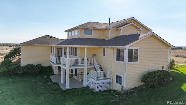 back of property featuring a lawn and a patio area