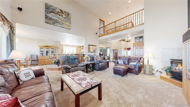 living room featuring a towering ceiling and light colored carpet