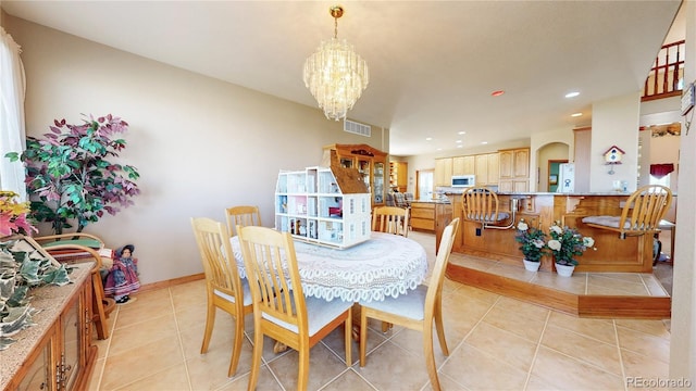 tiled dining space with an inviting chandelier