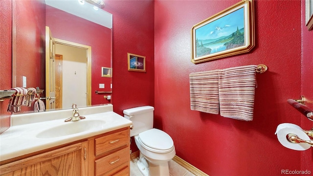 bathroom featuring vanity, toilet, and tile patterned floors