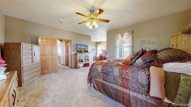 bedroom with light carpet and ceiling fan