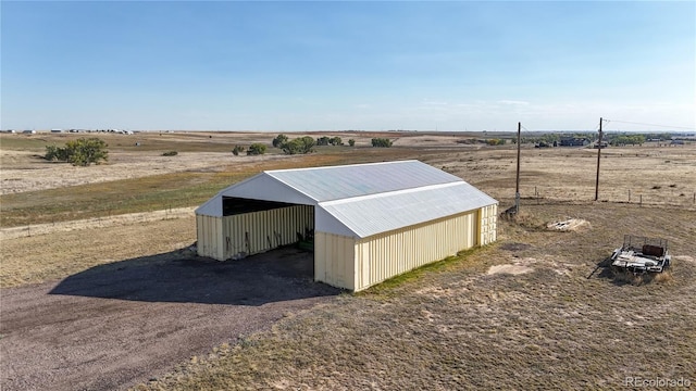 view of outdoor structure with a rural view