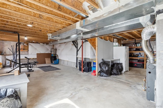 unfinished below grade area featuring freestanding refrigerator