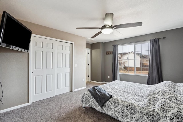bedroom with a closet, baseboards, carpet, and ceiling fan