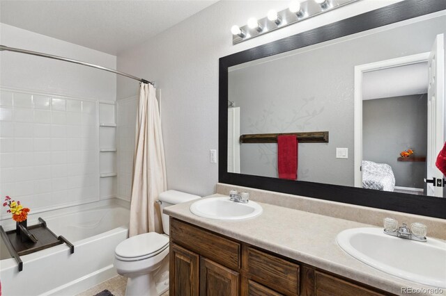 bathroom with double vanity, toilet, shower / tub combo with curtain, and a sink