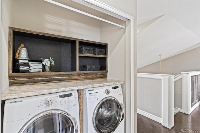 laundry room featuring washer and dryer, dark wood-type flooring, and laundry area