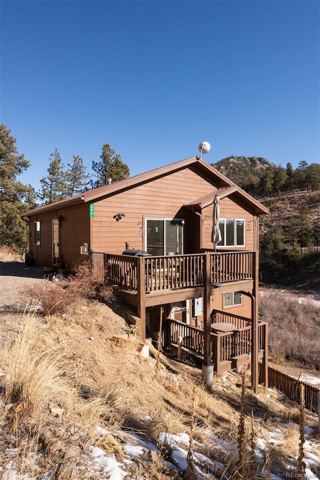 back of house with a wooden deck