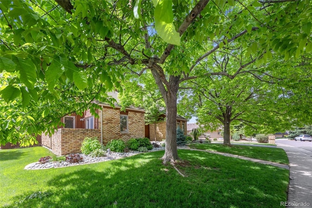 10886 E Crestline Cir, Englewood, CO 80111 - view of front of home featuring brick siding and a front yard