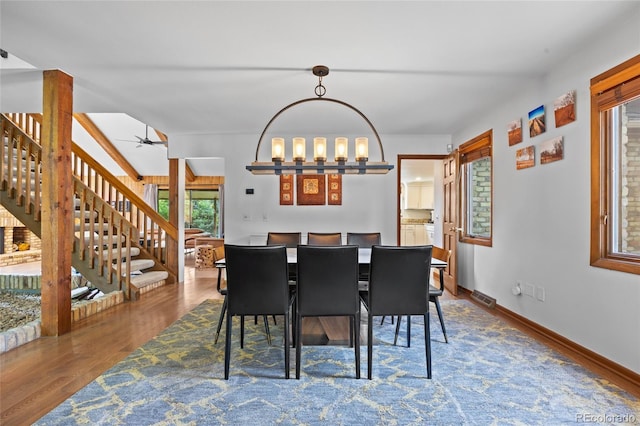10886 E Crestline Cir, Englewood, CO 80111 - dining area with stairs, wood finished floors, a ceiling fan, and a chandelier