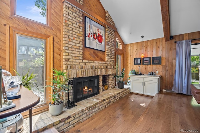 10886 E Crestline Cir, Englewood, CO 80111 - living area featuring a brick fireplace, wood-type flooring, and wooden walls