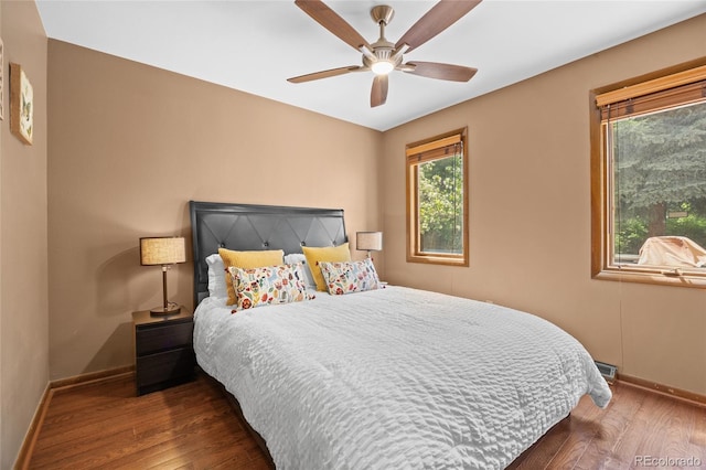 10886 E Crestline Cir, Englewood, CO 80111 - bedroom with wood finished floors, multiple windows, and ceiling fan