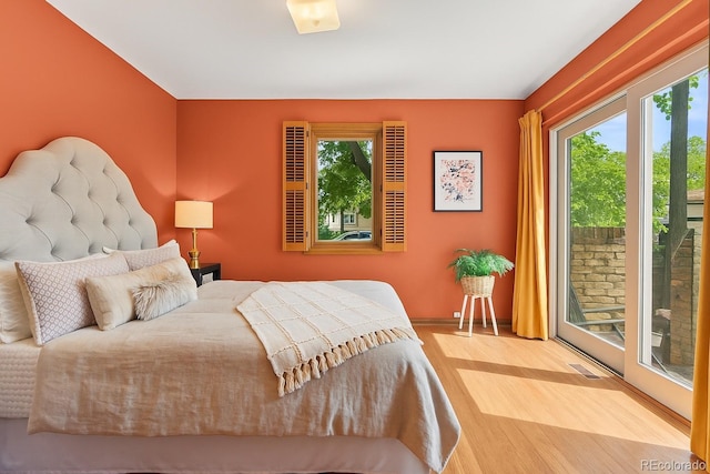 10886 E Crestline Cir, Englewood, CO 80111 - bedroom with multiple windows, wood finished floors, and access to outside