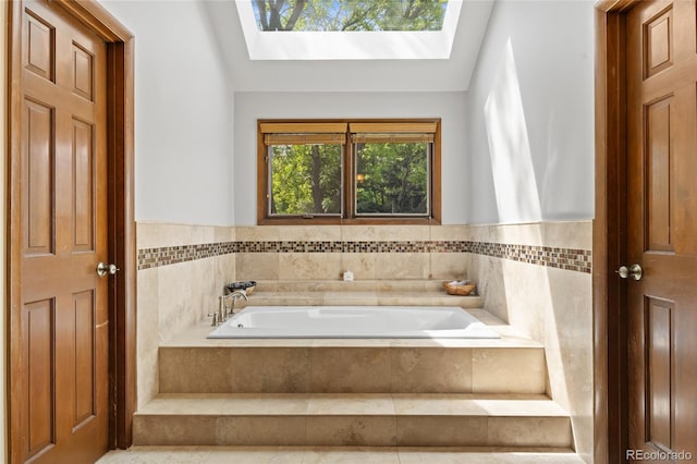 10886 E Crestline Cir, Englewood, CO 80111 - full bathroom with a garden tub, a skylight, tile walls, and wainscoting