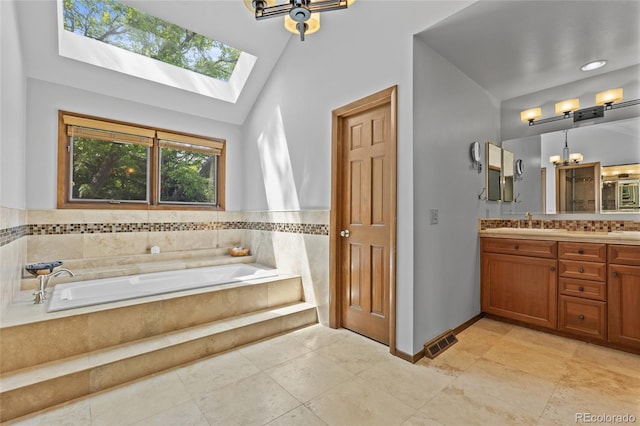 10886 E Crestline Cir, Englewood, CO 80111 - full bath with vanity, a bath, a towering ceiling, a skylight, and a chandelier