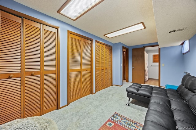 10886 E Crestline Cir, Englewood, CO 80111 - carpeted living area featuring a textured ceiling and baseboards