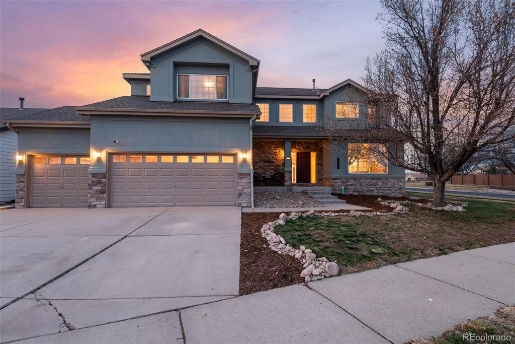 3685 Roberts St, Mead, CO 80542 - traditional home with concrete driveway, stucco siding, and stone siding