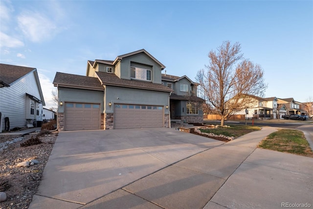craftsman-style home featuring stone siding, a residential view, a garage, stucco siding, and concrete driveway