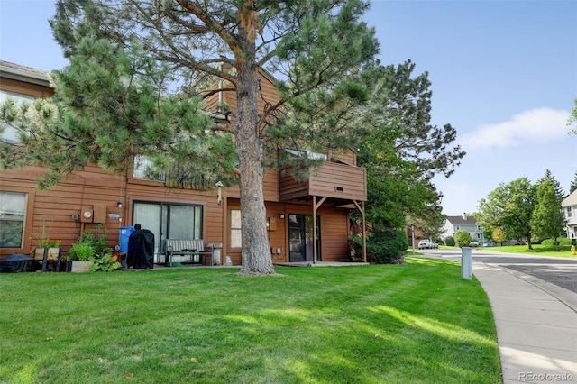 rear view of property featuring a yard