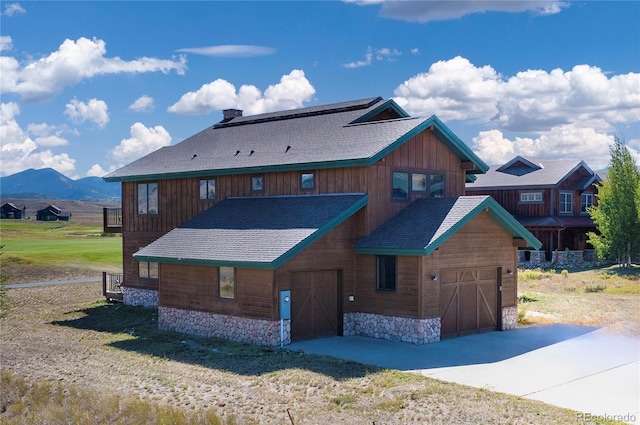 exterior space with a mountain view and a front yard