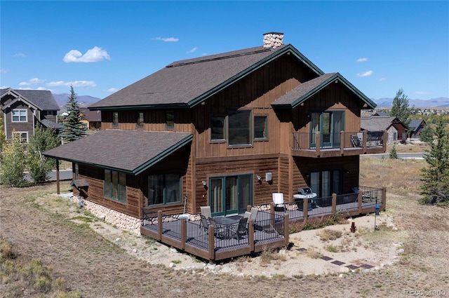 back of house featuring a deck and a balcony