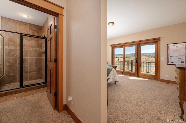 hallway featuring light carpet and a mountain view