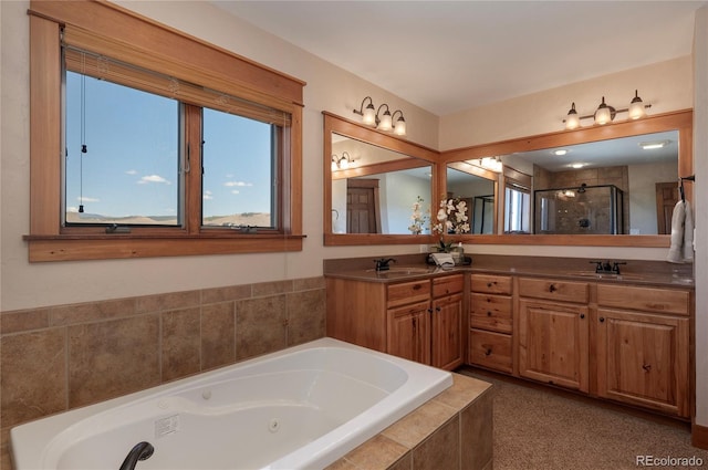 bathroom with vanity and shower with separate bathtub