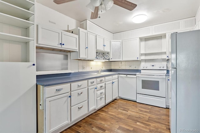 kitchen featuring wood-type flooring, ceiling fan, white appliances, and white cabinetry