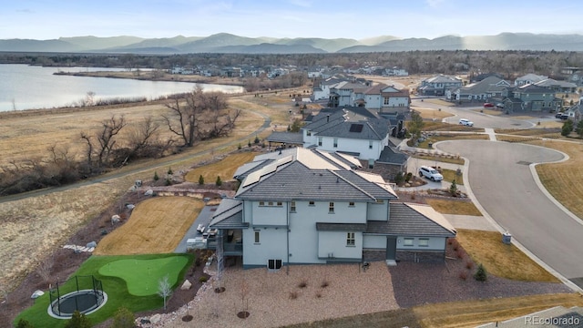 bird's eye view with a residential view and a water and mountain view