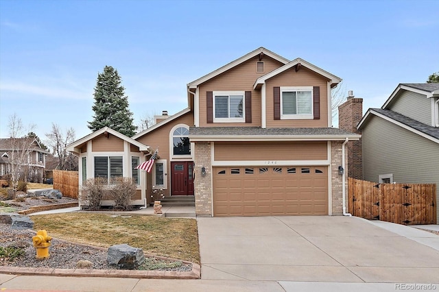 view of front of property with a garage, brick siding, concrete driveway, and fence