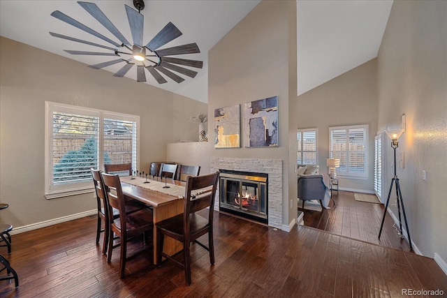 dining space with hardwood / wood-style floors, a fireplace, and a wealth of natural light