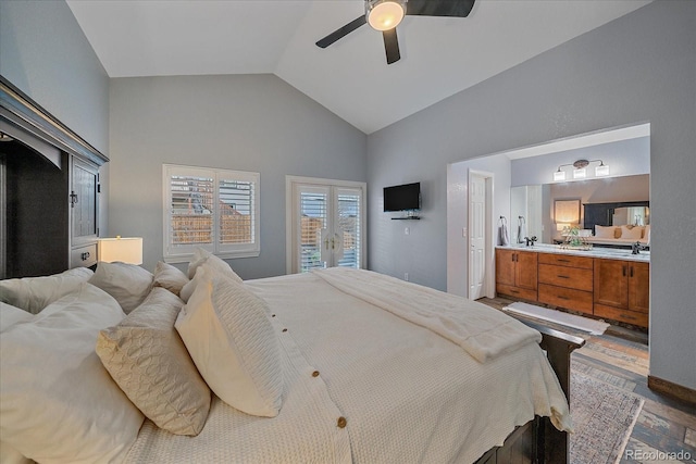 bedroom featuring access to exterior, connected bathroom, ceiling fan, lofted ceiling, and a sink